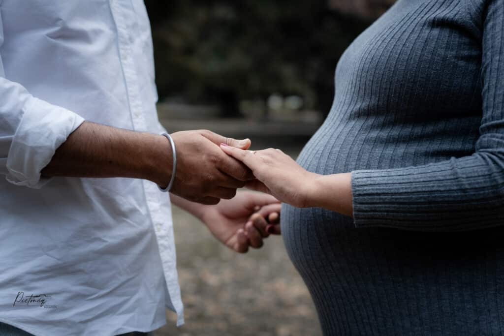 Partner reading to baby bump, Perth maternity