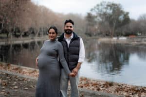 Pregnant woman sitting on park bench, Perth