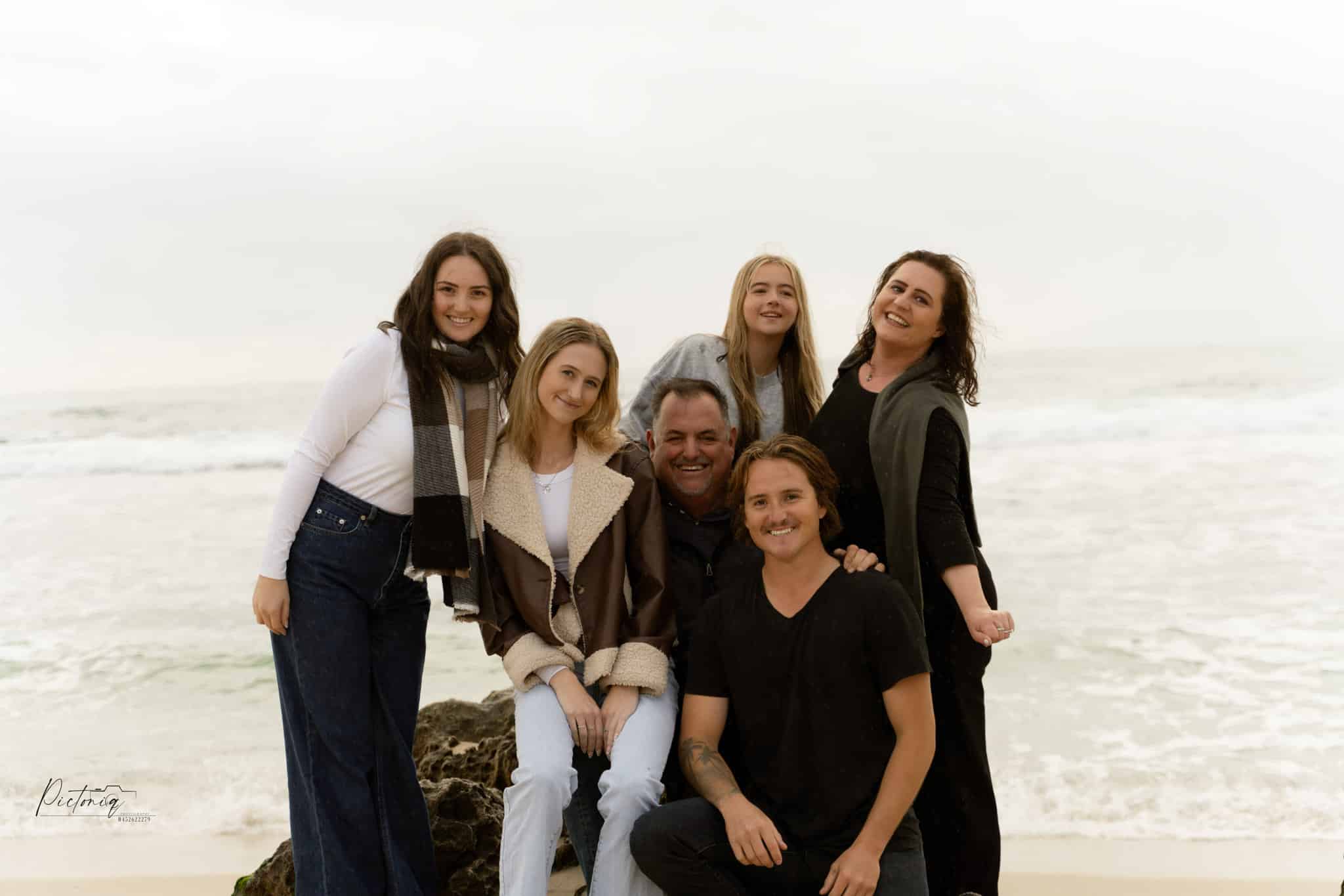 Group of people posing at beach