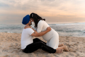Partner kissing baby bump, Trigg Beach sunset session