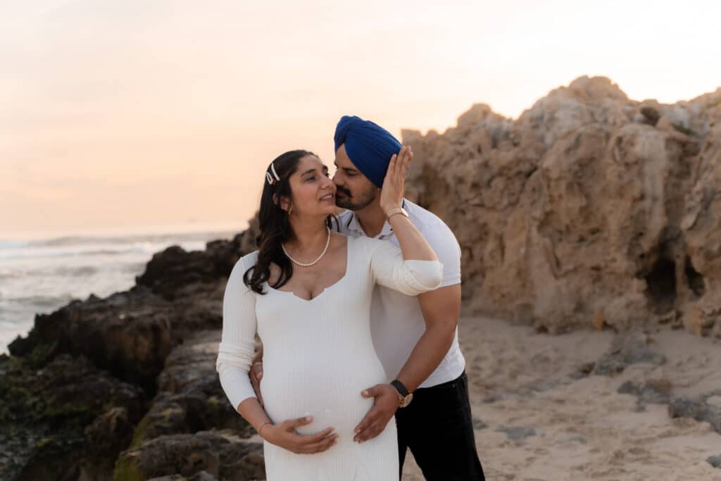 Family maternity photo on Trigg Beach rocks at sunset