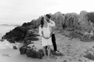 Couple walking barefoot on Trigg Beach at sunset