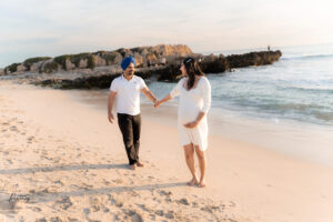 Partner embracing expecting mother, Trigg Beach sunse