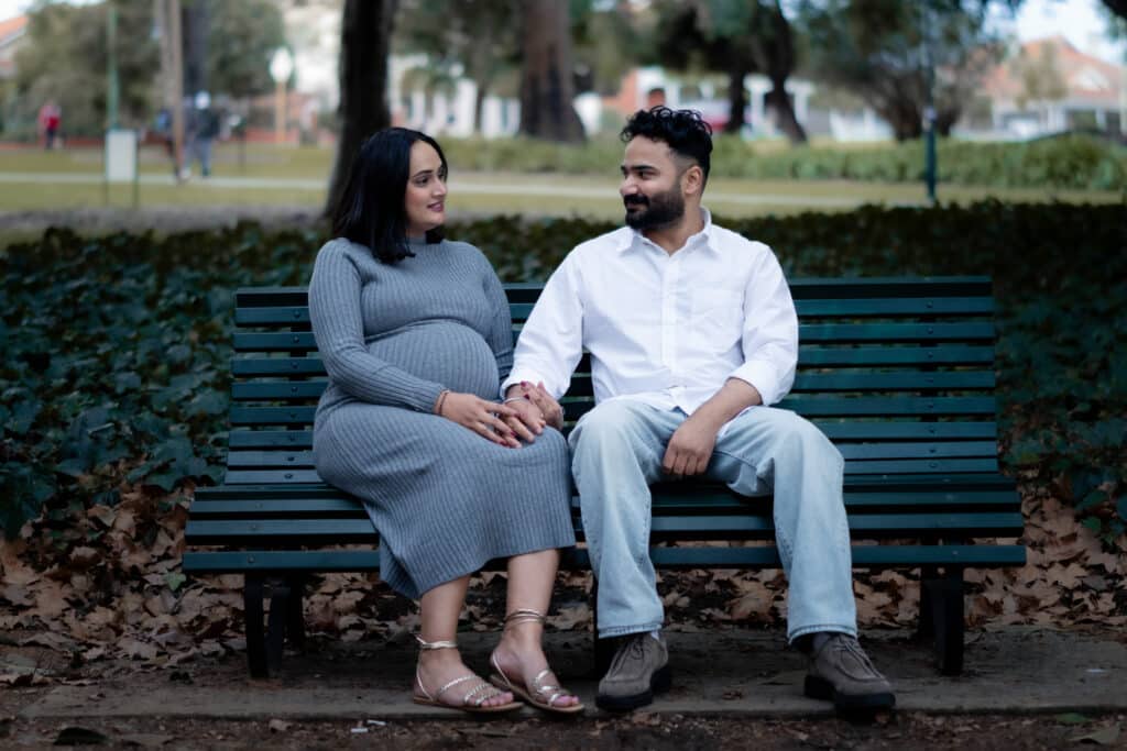Couple sitting on grass, Perth maternity session