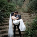 Home 116 Professional Event Photographer in Perth | a man and woman kissing on stairs