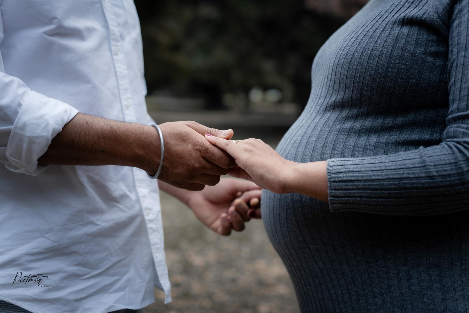 Partner reading to baby bump, Perth maternity